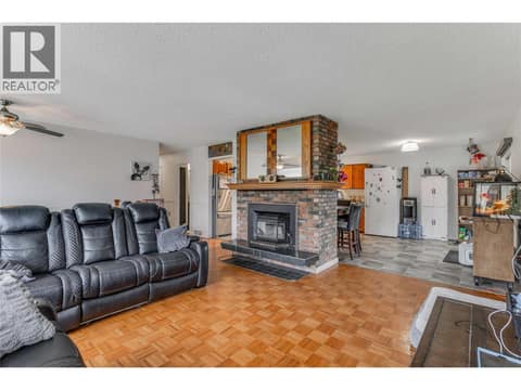 Living room with kitchen in the background at 3341 Webber Road, Glenrosa, West Kelowna