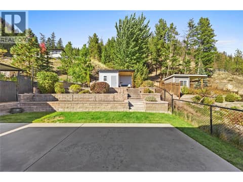 Backyard accessible via your kitchen. Landscaping includes retaining and 2 level areas to enjoy, private and spacious. Shed is powered and has an outdoor seating area attached. at 2322 Shannon Heights Place, Shannon Lake, West Kelowna