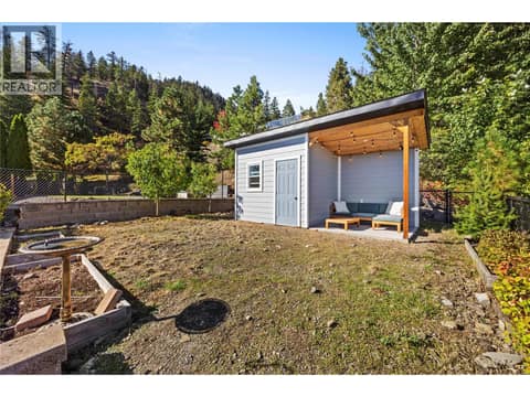 Powered shed in backyard with outdoor lounge area. at 2322 Shannon Heights Place, Shannon Lake, West Kelowna