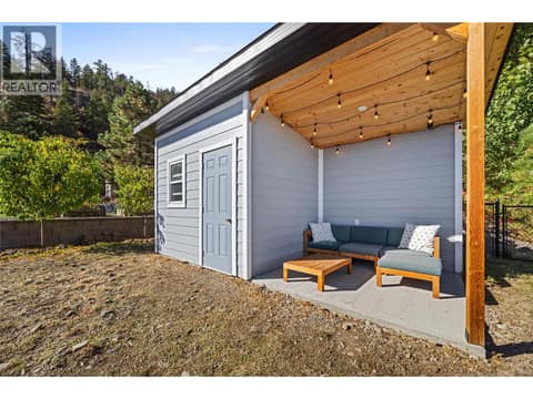 Powered shed in backyard with outdoor lounge area. at 2322 Shannon Heights Place, Shannon Lake, West Kelowna