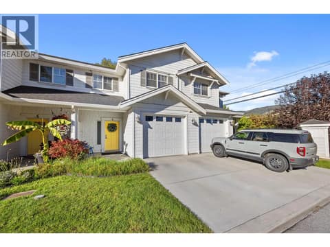 Full size driveway that will easily fit your truck or car with a single attached garage offering grade level entry to your main floor living space. at 10724 Bottom Wood Lake Road Unit# 4, Lake Country South West