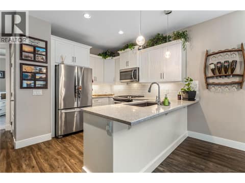Beautiful white custom kitchen, wider than many other units in the complex. Main floor. at 3359 Cougar Road Unit# 60, Westbank Centre, West Kelowna