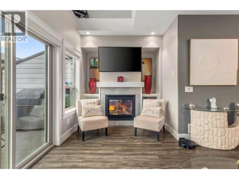 Large gas fireplace with custom  entertainment unit. at 3359 Cougar Road Unit# 60, Westbank Centre, West Kelowna