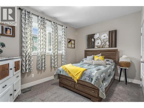 Large guest bedroom on main floor. at 3359 Cougar Road Unit# 60, Westbank Centre, West Kelowna