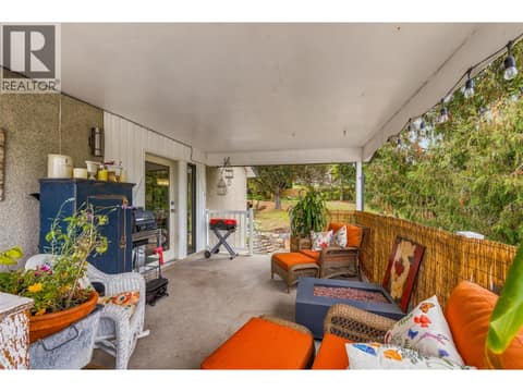 Deck has stairs down to fenced backyard at 2350 Thacker Drive, Lakeview Heights, West Kelowna