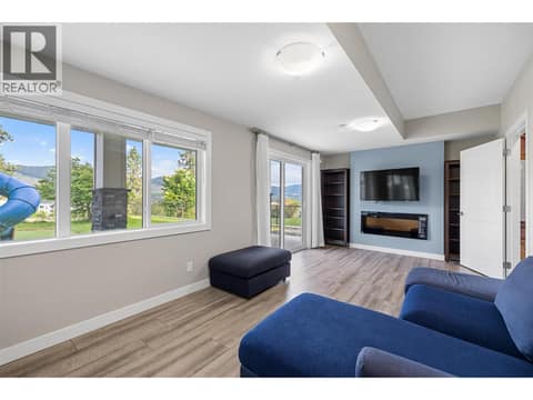 Basement rec room for the main home with cozy and relaxing fireplace area, sliding door to the backyard at 695 Concordia Street, University District, Kelowna
