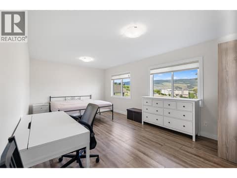 Upstairs Primary bedroom with two windows at 695 Concordia Street, University District, Kelowna