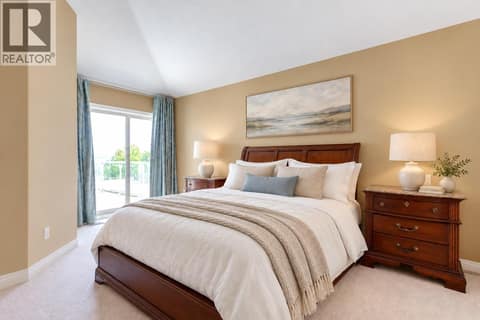 Primary Bedroom with patio doors to the deck and lake views. at 4074 Gellatly Road Unit# 221, Westbank Centre, West Kelowna