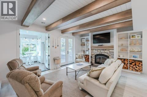 Living room with wood-burning Napoleon fireplace at 2450 Radio Tower Road Unit# 58, Oliver Rural