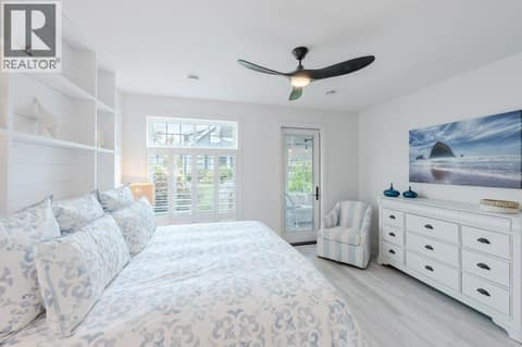 Primary bedroom with sunroom access at 2450 Radio Tower Road Unit# 58, Oliver Rural
