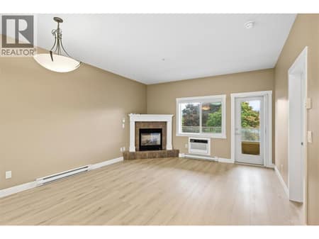 Large window and access to the east-facing balcony at 1125 Bernard Avenue Unit# 302, Kelowna North