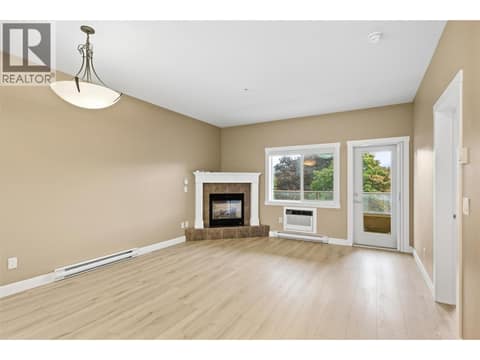 Large window and access to the east-facing balcony at 1125 Bernard Avenue Unit# 302, Kelowna North