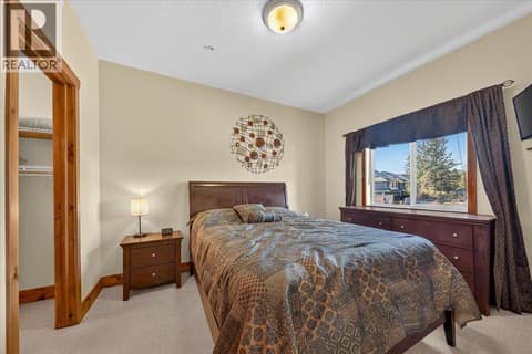 Primary bedroom with ensuite bathroom and walk in closet at 701 14A Crescent Unit# 214, Invermere