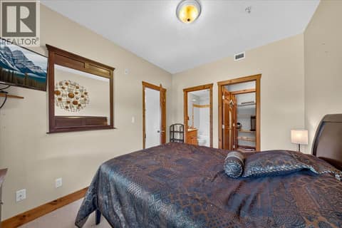 Primary bedroom with ensuite bathroom and walk in closet at 701 14A Crescent Unit# 214, Invermere