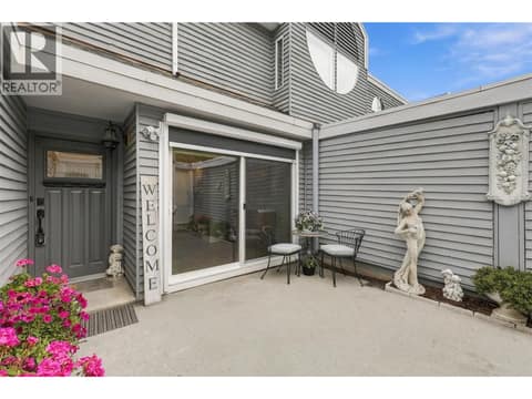 Courtyard with sliding patio doors with remote blinds at 1795 Summit Drive Unit# 11, Sahali, Kamloops