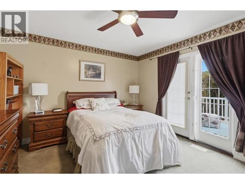 Primary bedroom with doors leading to sundeck at 723 Moody Place, Brocklehurst, Kamloops