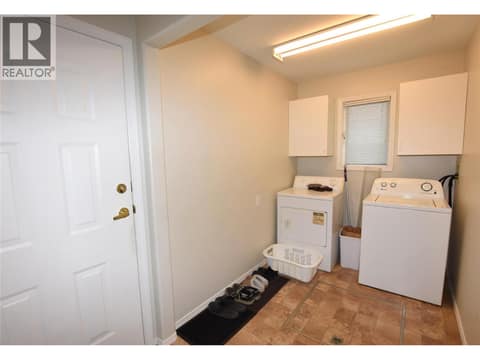 Laundry area and door to the garage at 415 4 Street, Swan Lake West, Vernon