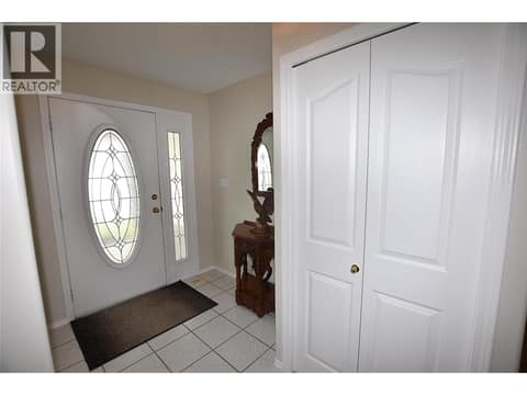 Step inside to a spacious tiled entry with a coat closet at 415 4 Street, Swan Lake West, Vernon