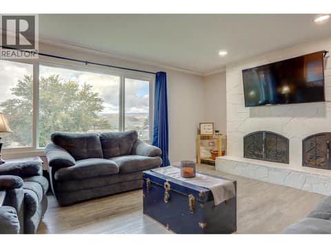 Living room with wood burning fireplace at 5723 Richards Crescent, North BX, Vernon