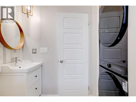 Main Bathroom with stacking laundry at 5723 Richards Crescent, North BX, Vernon