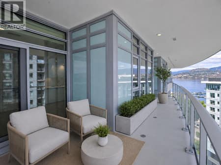 Expansive wraparound balcony with covered outdoor seating, lake and mountain views, and an elevated outlook over Aqua’s waterfront setting. *virtually staged at 3699 Capozzi Road Unit# PH6, Lower Mission, Kelowna