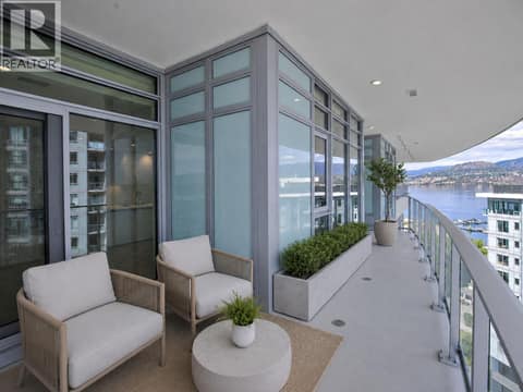 Expansive wraparound balcony with covered outdoor seating, lake and mountain views, and an elevated outlook over Aqua’s waterfront setting. *virtually staged at 3699 Capozzi Road Unit# PH6, Lower Mission, Kelowna