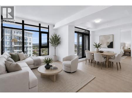Floor to ceiling windows fill the open concept living space with natural light and connect seamlessly to the expansive outdoor entertaining area. *virtually staged at 3699 Capozzi Road Unit# PH6, Lower Mission, Kelowna