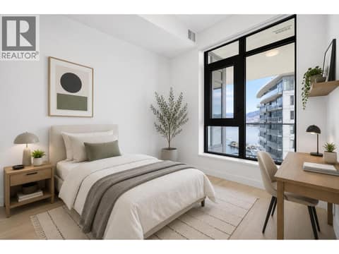 Second bedroom with floor to ceiling windows, lake and mountain outlooks, and flexible space for guests, family or a stylish home office. *virtually staged at 3699 Capozzi Road Unit# PH6, Lower Mission, Kelowna