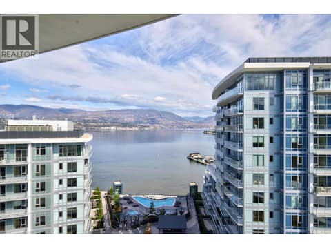 Sweeping penthouse outlook with views across Okanagan Lake, the resort amenities below and the surrounding mountains beyond. at 3699 Capozzi Road Unit# PH6, Lower Mission, Kelowna