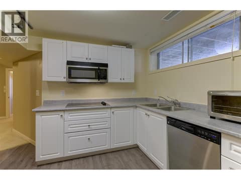Kitchen w/ Stainless Steel Appliances and new Fridge at 565 Dougall Road S, Rutland South, Kelowna