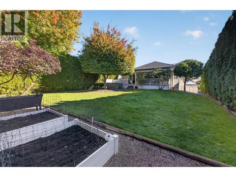 Garden beds and large grassy yard at 1380 Loseth Drive, Black Mountain, Kelowna