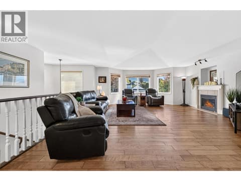 Open concept living with cozy fireplace at 1380 Loseth Drive, Black Mountain, Kelowna