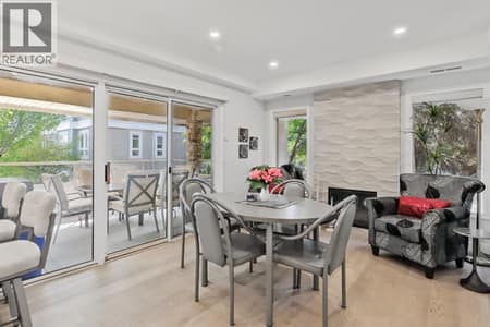 Nook & sitting area with cozy gas fireplace and deck access at 3335 Richter Street Unit# 201, Lower Mission, Kelowna