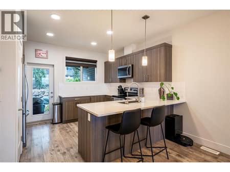 Lovely, open plan U shaped kitchen with eating bar and walkout to back yard & patio at 881 Mt.Ida Drive, Middleton Mountain Vernon