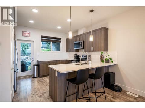 Lovely, open plan U shaped kitchen with eating bar and walkout to back yard & patio at 881 Mt.Ida Drive, Middleton Mountain Vernon