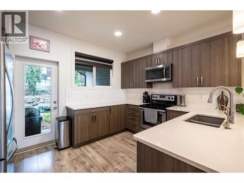 Upper level main kitchen with walkout to the back yard & patio at 881 Mt.Ida Drive, Middleton Mountain Vernon