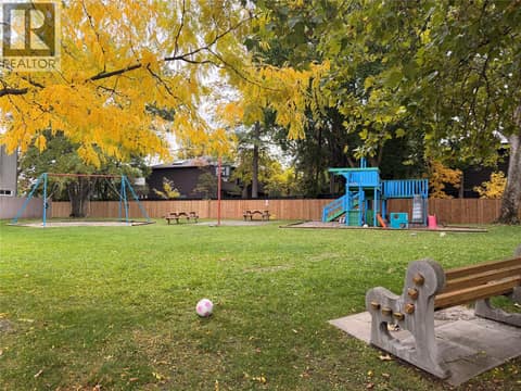 Playground with swing set and basketball hoop at 1985 Burtch Road Unit# 24, Springfield/Spall, Kelowna