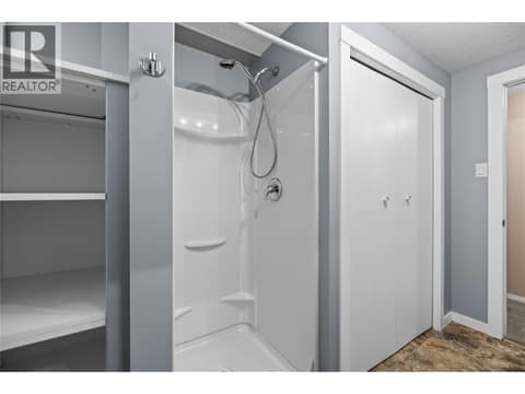 Lower Level - Bathroom with Shower and Built-In Storage at 3000 Richter Street Unit# 6, Kelowna South