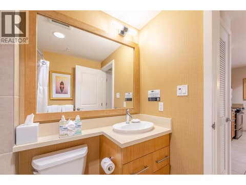 Bathroom vanity with broad mirror and storage. at 15 PARK Place Unit# 209, Osoyoos