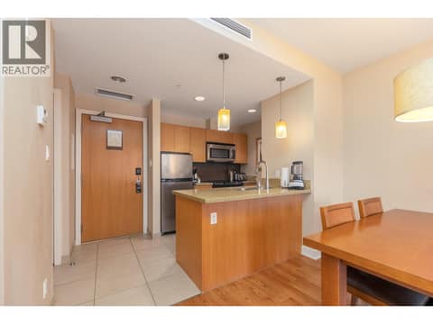 Open dining area beside the kitchen and front entry. at 15 PARK Place Unit# 209, Osoyoos