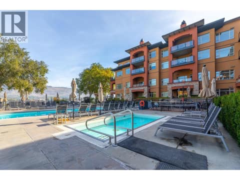 Outdoor pool and hot tub area within the resort courtyard. at 15 PARK Place Unit# 209, Osoyoos