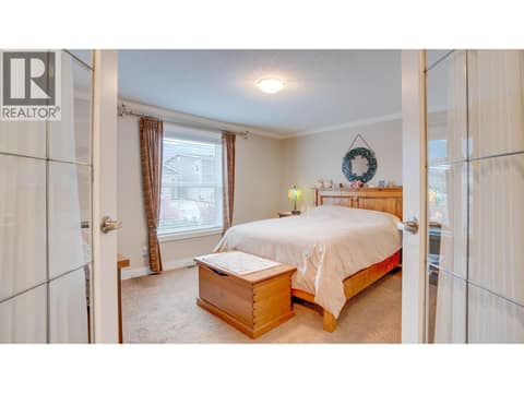 Primary bedroom with French doors at 12560 Westside Road Unit# 15, Swan Lake West, Vernon