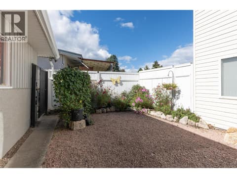 Fenced - Inner courtyard with access to Side Entrance to the Basement and Garage Access at 1296 Kelglen Crescent, Glenmore, Kelowna