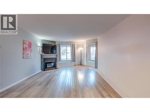 Livingroom with corner gas fireplace. at 3705 30 Avenue Unit# 104, City of Vernon