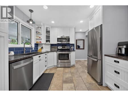 Functional kitchen with stainless steel appliances at 175 Venus Road, Rutland South, Kelowna