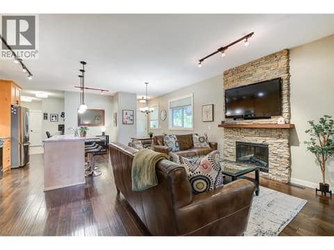 Living room with stone feature electric fireplace at 511 Yates Road Unit# 110, North Glenmore, Kelowna