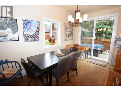 Dining space beside the kitchen with sliders to the back yard at 430 Hummingbird Avenue, Okanagan North, Vernon