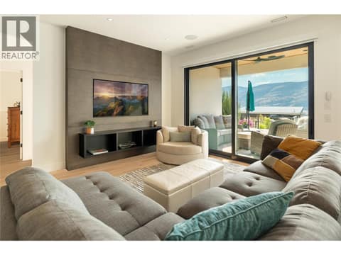 Custom built in storage cabinets and inset TV at 538 Clifton Court, Glenmore, Kelowna