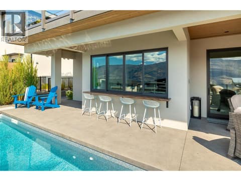 Live Edge Bar Top on exterior with 4 bar chairs (included) at 538 Clifton Court, Glenmore, Kelowna