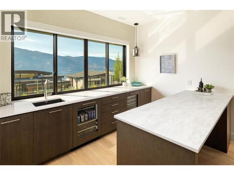 Wet Bar with Beverage Fridge and wine fridge at 538 Clifton Court, Glenmore, Kelowna